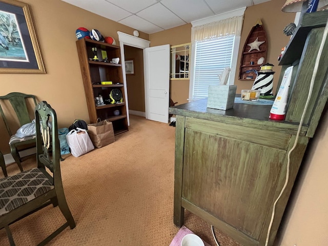 carpeted home office featuring a drop ceiling