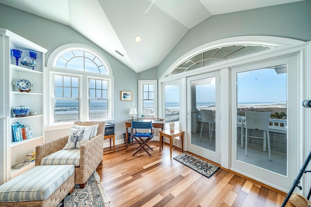 sunroom featuring vaulted ceiling and visible vents