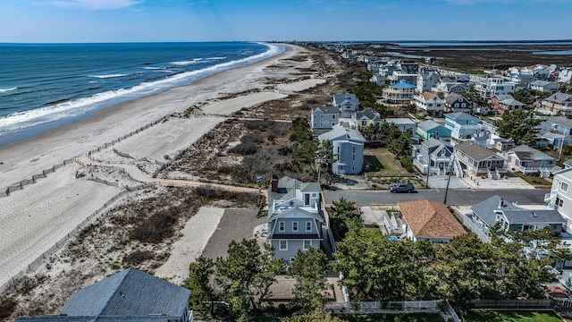 bird's eye view featuring a water view, a residential view, and a view of the beach