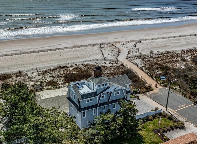 birds eye view of property featuring a water view and a view of the beach