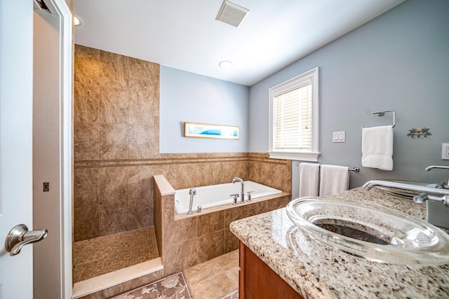 full bath featuring visible vents, a sink, a bath, tiled shower, and tile patterned floors