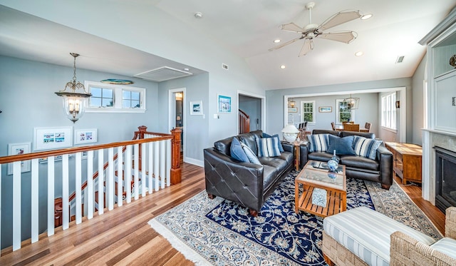 living room with recessed lighting, wood finished floors, visible vents, vaulted ceiling, and attic access