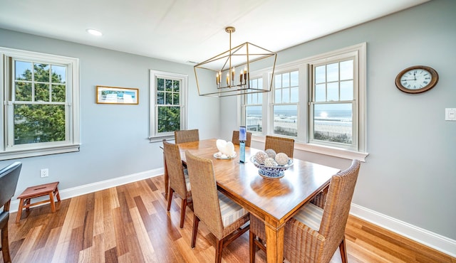 dining space featuring recessed lighting, an inviting chandelier, light wood-style flooring, and baseboards