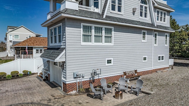 view of side of property with fence and a patio