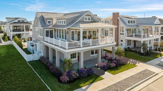 back of property featuring a yard and a balcony