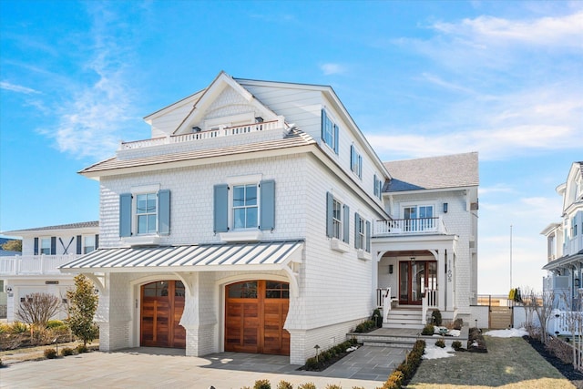 view of front of home featuring a garage and a balcony