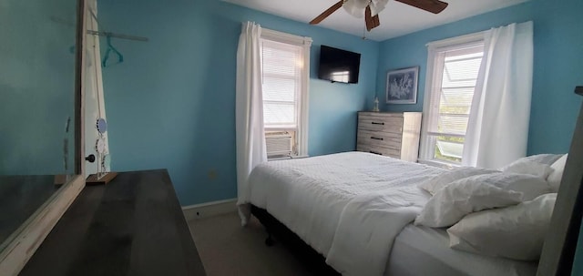 bedroom with ceiling fan and cooling unit