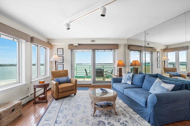 9400 Roberts Ave Unit 306, Sea Isle City, NJ 08243 - living room featuring plenty of natural light, hardwood / wood-style flooring, baseboard heating, and track lighting