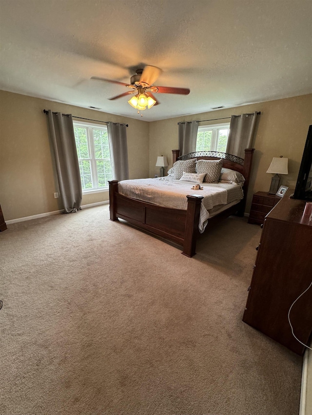 bedroom featuring a textured ceiling, carpet floors, and ceiling fan