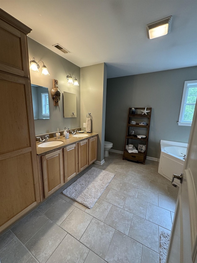 bathroom featuring a bath, vanity, and toilet