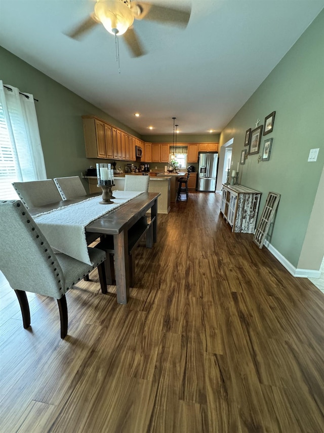 dining room featuring ceiling fan and dark hardwood / wood-style flooring