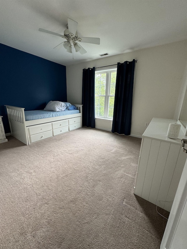 carpeted bedroom with ceiling fan