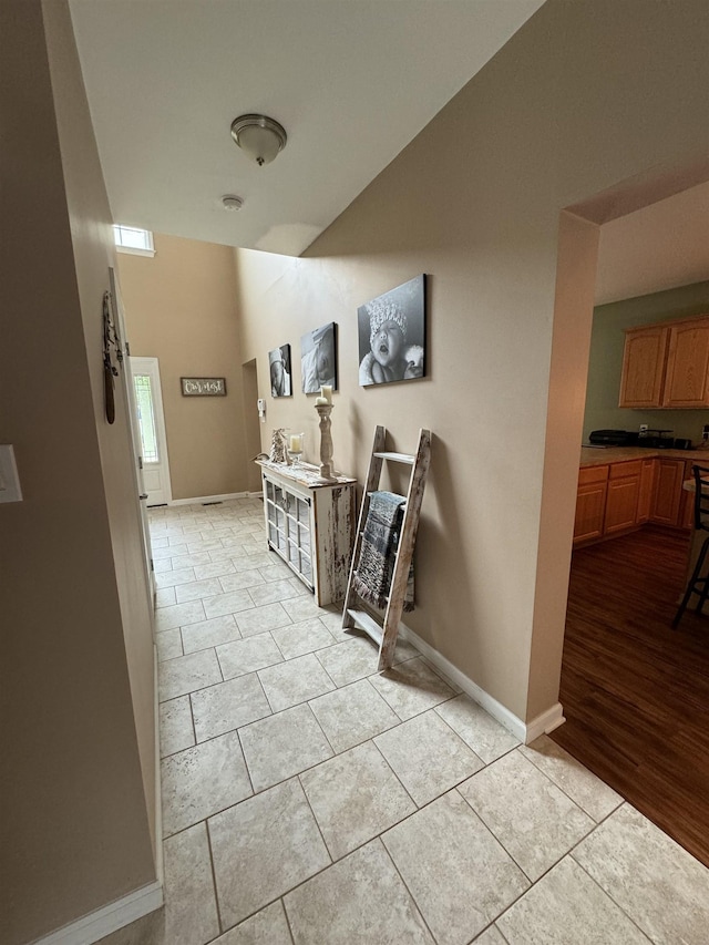 hall featuring light tile patterned floors