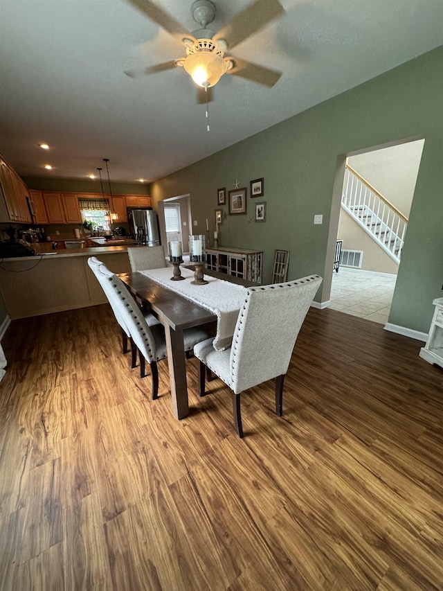 dining area with light hardwood / wood-style floors and ceiling fan