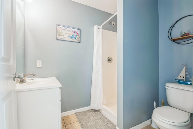 bathroom featuring toilet, a shower with curtain, vanity, and tile patterned floors