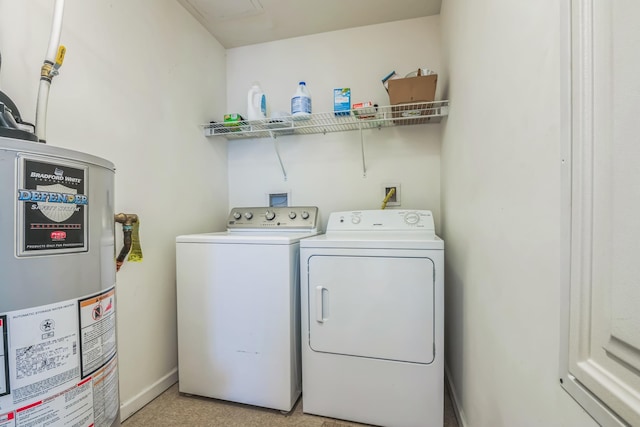 clothes washing area featuring separate washer and dryer and water heater