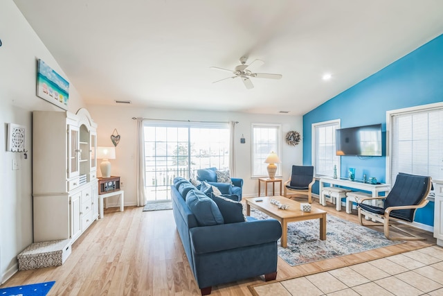 living room featuring ceiling fan, light wood-type flooring, and lofted ceiling