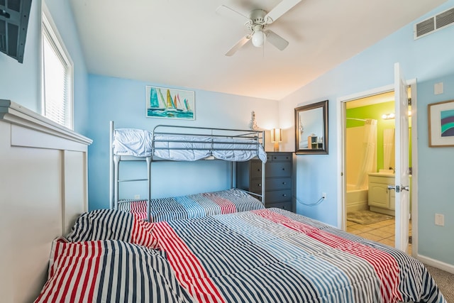 bedroom with ensuite bath, ceiling fan, and lofted ceiling