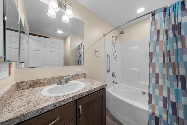 bathroom with wood-type flooring, vanity, and shower / bathtub combination with curtain