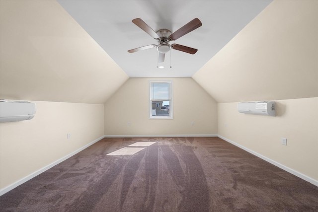 additional living space featuring dark colored carpet, ceiling fan, an AC wall unit, and vaulted ceiling