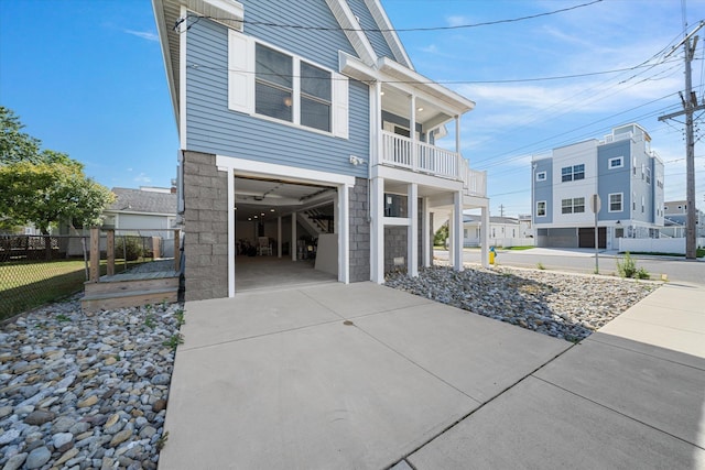 view of home's exterior with a balcony and a garage