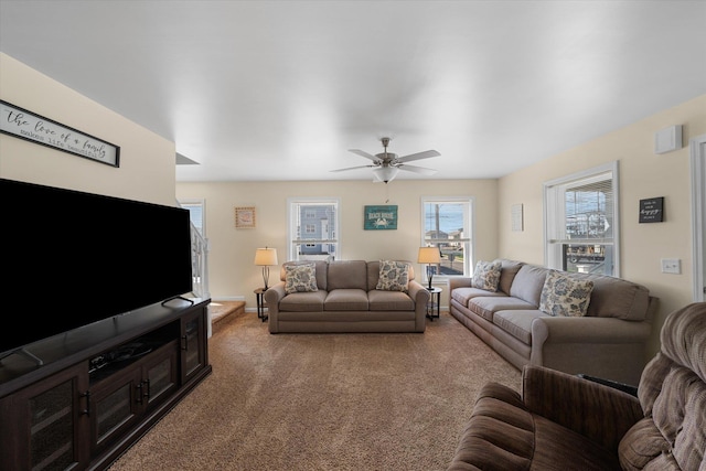 living room featuring ceiling fan and carpet