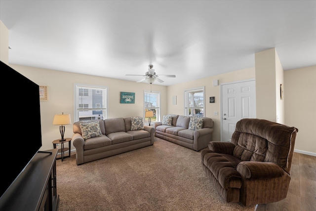 living room with light hardwood / wood-style flooring, ceiling fan, and a healthy amount of sunlight