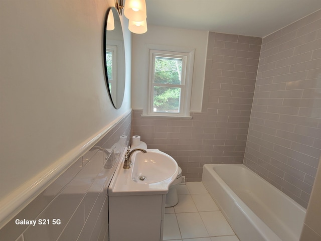 bathroom featuring tile patterned flooring, vanity, and tile walls