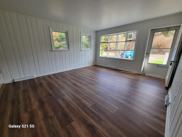 spare room with dark hardwood / wood-style flooring