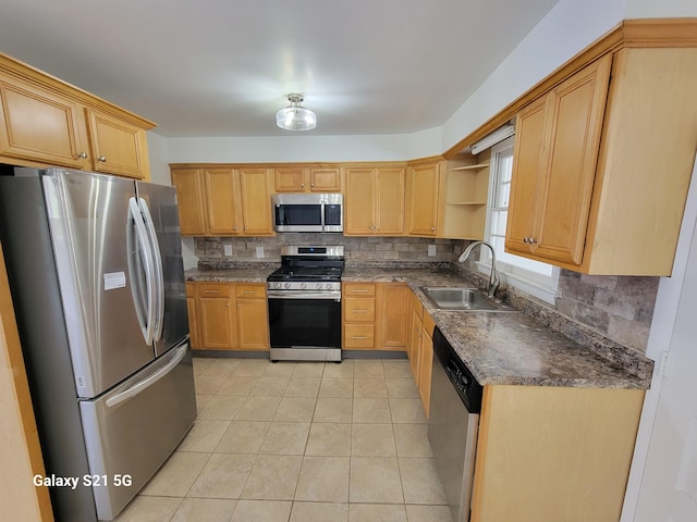 kitchen featuring light tile patterned flooring, appliances with stainless steel finishes, sink, and decorative backsplash