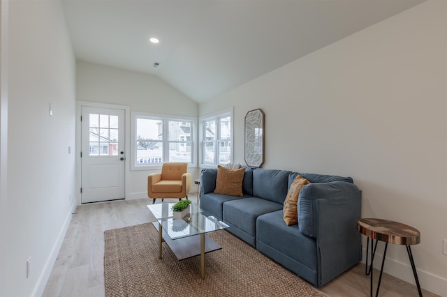 living room featuring lofted ceiling, recessed lighting, visible vents, light wood-style flooring, and baseboards