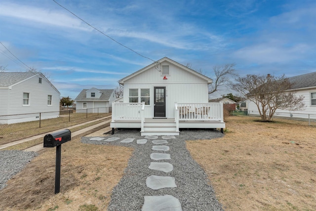 view of front of house featuring a deck and fence