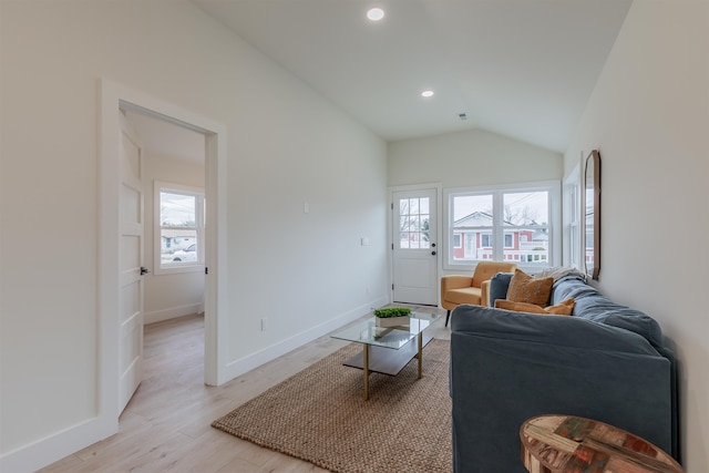 living room featuring lofted ceiling, recessed lighting, light wood-style flooring, and baseboards