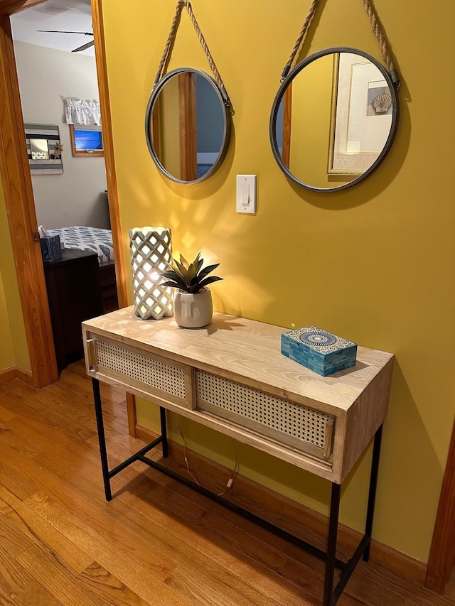 room details featuring baseboards and wood finished floors