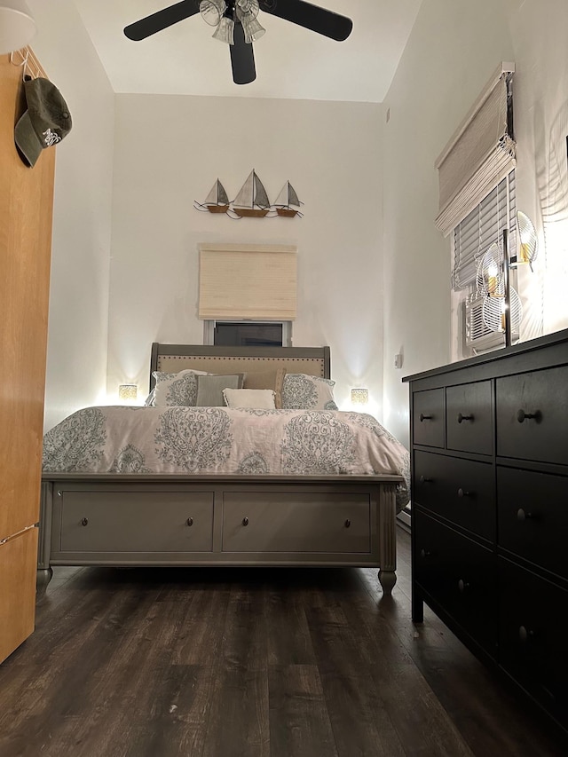 bedroom with a ceiling fan and dark wood-style floors
