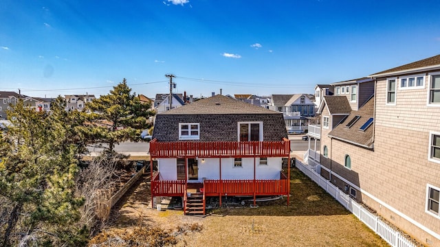 rear view of property featuring a yard and a deck