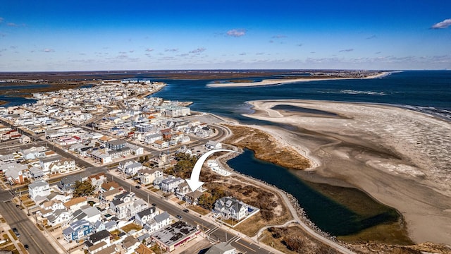 drone / aerial view with a water view and a beach view