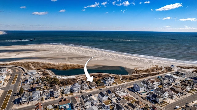 drone / aerial view with a beach view and a water view