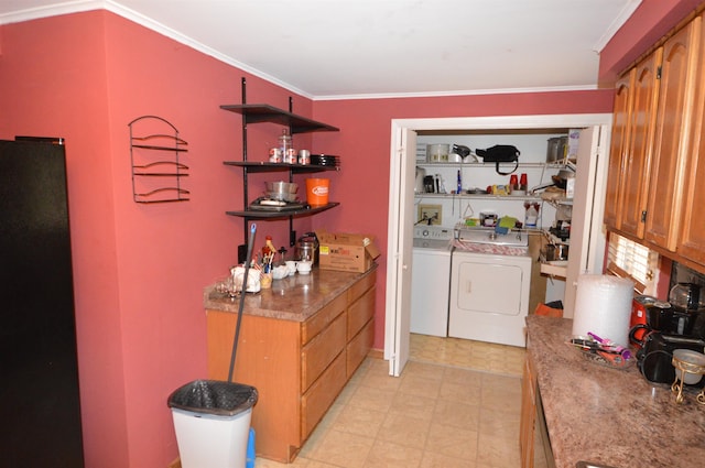 laundry area featuring washing machine and dryer and ornamental molding