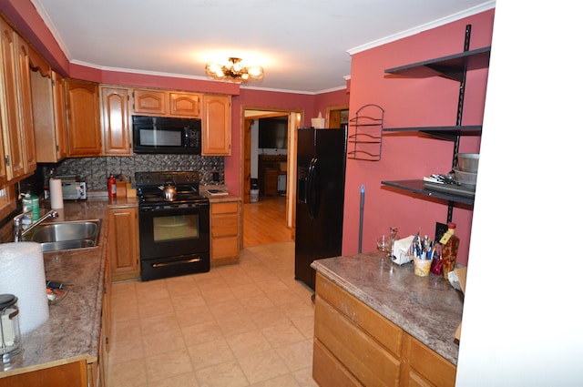 kitchen with black appliances, tasteful backsplash, crown molding, and sink