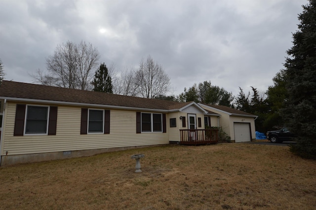 view of front of home with a deck, a front yard, and a garage