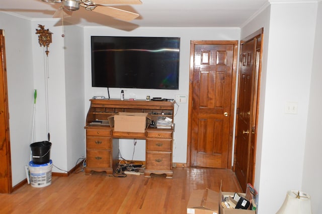 unfurnished living room featuring ornamental molding, ceiling fan, and light hardwood / wood-style floors