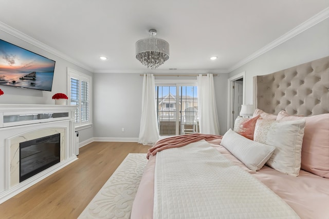 bedroom featuring light wood-style flooring, recessed lighting, a fireplace, crown molding, and baseboards