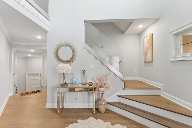 staircase featuring recessed lighting, baseboards, wood finished floors, and ornamental molding