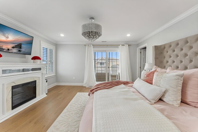 407 Paradise Way Unit 1, North Wildwood, NJ 08260 - bedroom with baseboards, ornamental molding, a fireplace, light wood-style floors, and a notable chandelier