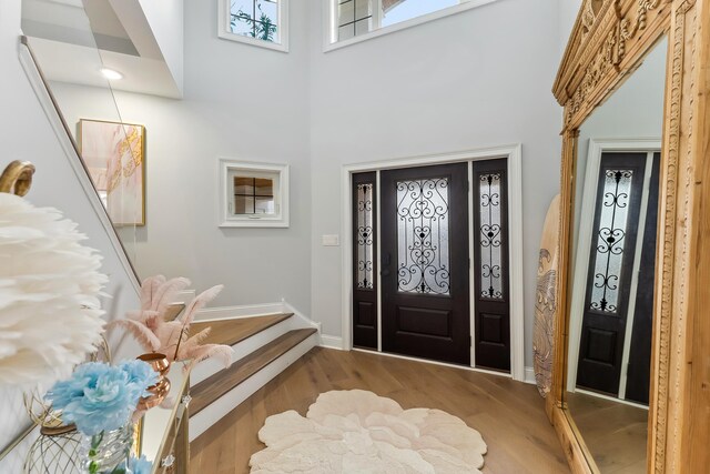 407 Paradise Way Unit 1, North Wildwood, NJ 08260 - foyer with a towering ceiling, baseboards, stairway, and wood finished floors