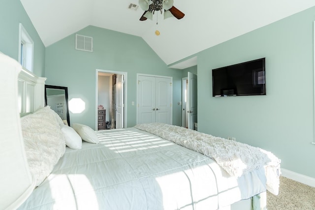 carpeted bedroom with lofted ceiling, ceiling fan, a closet, and visible vents