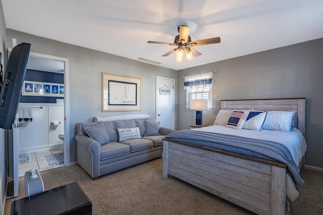 bedroom featuring carpet floors, visible vents, connected bathroom, and a ceiling fan