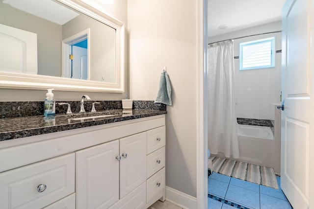 bathroom featuring baseboards, tile patterned flooring, vanity, and shower / tub combo with curtain