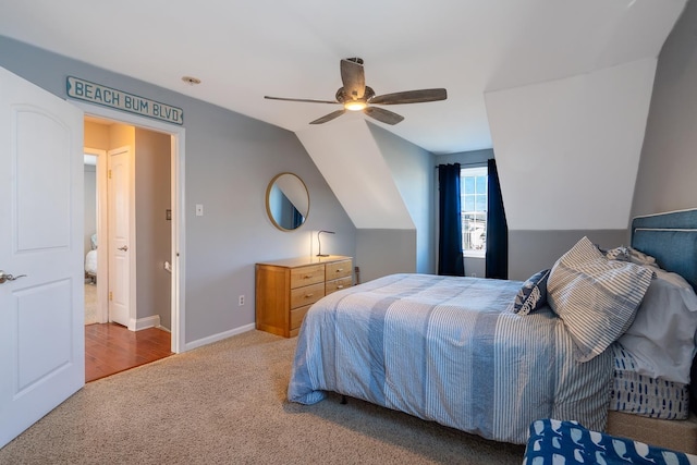 carpeted bedroom featuring ceiling fan, baseboards, and vaulted ceiling